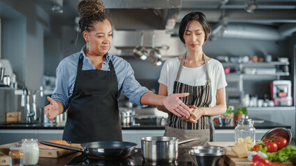 Celebrity TV Cooking Show Kitchen: Asian and Black Female Chefs Talk, Teach How to Cook Food. Online Video Courses, Television Program Presenters. Preparation of Healthy Traditional Fusion Dish Recipe