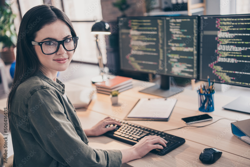 Poster Profile side view portrait of attractive skilled cheery girl tech support writing html code css php at workplace workstation indoors