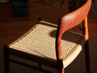 A danish mid century modern teak chair from the 60s vintage standing in the dining living room with...
