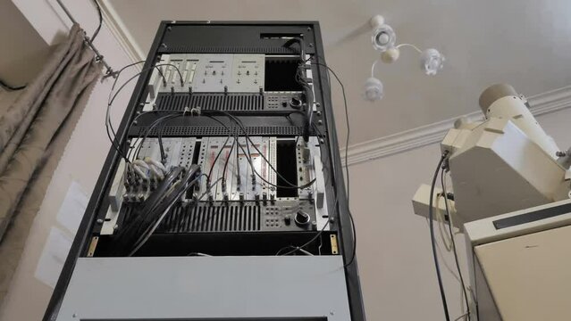 Machine Operating Electronic Console In Factory in Old Style. Vintage Concept
