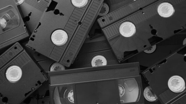 Messy stack of VHS tapes. Video Home System tape cassettes.