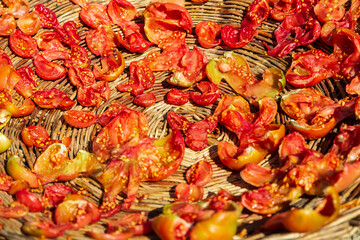 Tomatoes sun-dried lying in straw bowls Healthy food. Natural agricultural food. Traditional food of Kalash people. Chitral, Pakistan