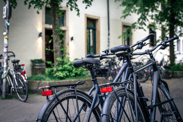 A group of bicycles in the parking lot, blurred background.