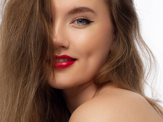 Fototapeta premium Glamour portrait of beautiful woman model with fresh daily makeup and romantic wavy hairstyle. Fashion shiny highlighter on skin, sexy gloss lips make-up and dark eyebrows