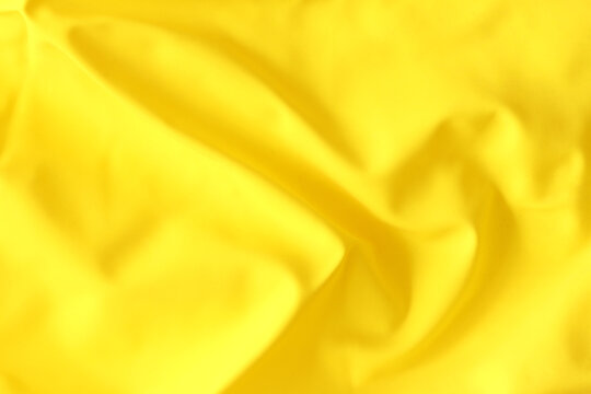 Yellow texture of crumpled rubber balloon. Crumpled rubber of a children's balloon.