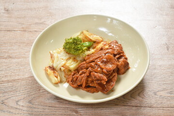 fried slice pork Sichuan pepper sauce and cabbage with broccoli on plate