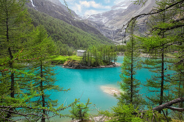 Amazing view on the blue lake between Alp mountains. Summer day, Switzerland. Alp Grum Lake, Graubunden. Bernina express