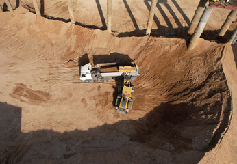 Wheel loader load sand in tipper truck in open pit. Front end loader on earthworks in open-pit...