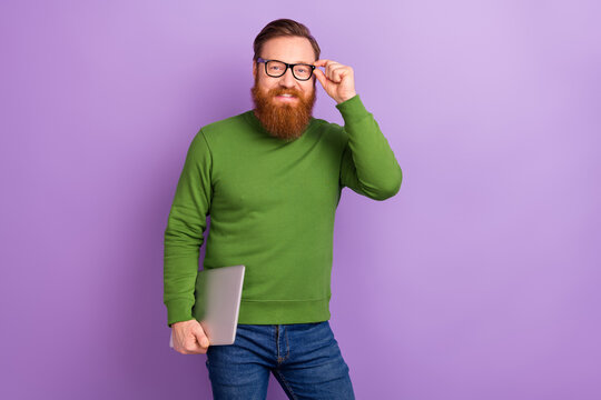 Photo of handsome positive young experienced freelancer man with netbook isolated on violet color background