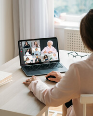 Web meeting. Video chat. Internet communication. Business woman working from home using laptop cooperating online with team on screen in virtual office.