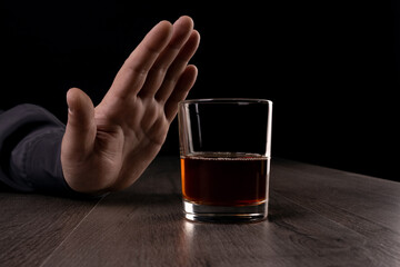 The man refuses to drink alcohol. Against alcohol.