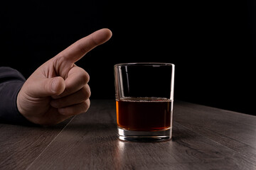 The man refuses to drink alcohol. Against alcohol.