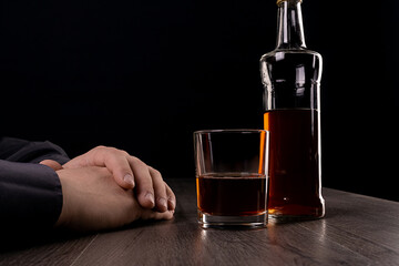 Drinking alcohol at the table in the dark.