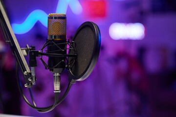 Horizontal no people selective focus shot of microphone with disc pop filter in modern recording...