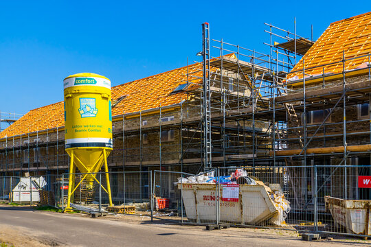 Beamix cement tower and waste container with houses in scaffolding at the construction site in Rucphen, The Netherlands, 6 may, 2022
