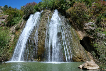 Fototapeta premium Waterfall landscape. Ayun's fall water stream. River Nahal Ayun . Nature Reserve and National park. Upper Galilee, Israel
