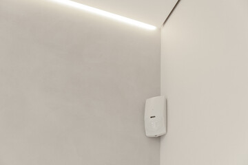 The motion sensor is installed in the corner of the room. Security alarm.