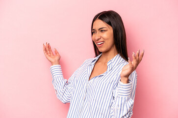 Young hispanic woman isolated on pink background joyful laughing a lot. Happiness concept.