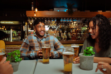 diverse group of friends out for drinks in restaurant
