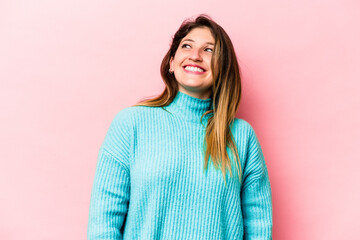 Young caucasian woman isolated on pink background relaxed and happy laughing, neck stretched showing teeth.