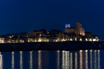 Fototapeta premium View of sea port in Cannes,France and its old town at night