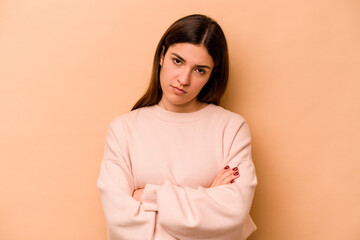 Young hispanic woman isolated on beige background who is bored, fatigued and need a relax day.