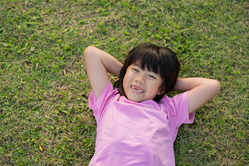 happy girl lying on the grass,  play ground