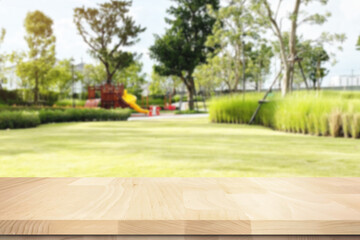 Empty wooden floor space with bright blurry outdoor environment with trees and garden  background for commercial product presentation display.