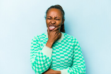 Young african american woman isolated on blue background having a strong teeth pain, molar ache.