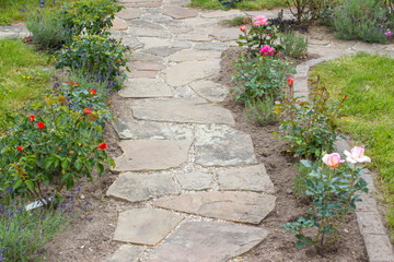 Naklejka premium stone paved garden path and flowers