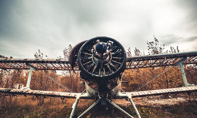 Abandoned old airplane lost on the airfield. Closeup view of broken rotor