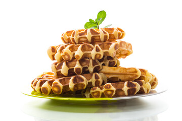 Sweet cottage cheese wafers with a sprig of mint in a plate