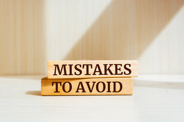 Wooden blocks with words 'Mistakes To Avoid'. Business concept - obrazy, fototapety, plakaty