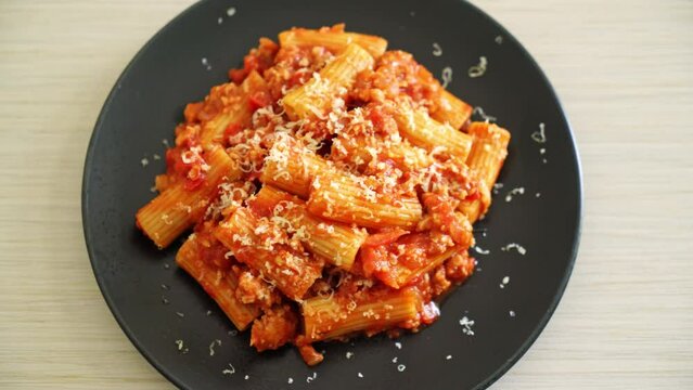 Bolognese rigatoni pasta with cheese - traditional Italian pasta