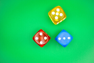 Gambling color dice on green casino style background