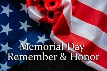 Fototapeta na wymiar Text Memorial Day on American flag And a poppy flower background 
