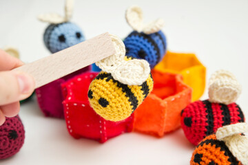 Blue and yellow crocheted bees and thread with crochet. DIY home made hand made baby rattle toy...