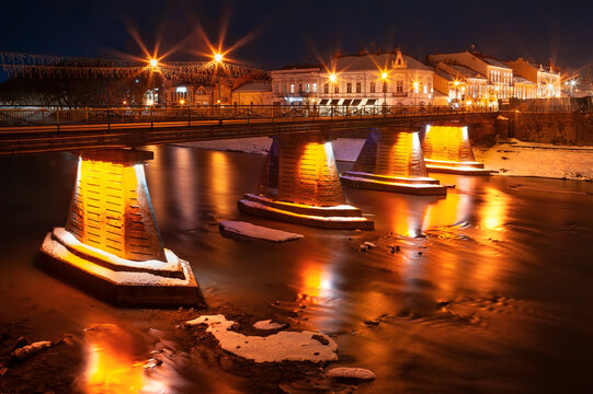 Night view of the pedestrian bridge across the river Uzh. Uzhgorod, Ukraine.