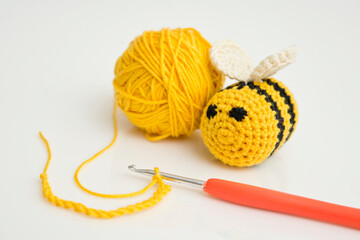 Yellow crocheted bees and thread with crochet. DIY home made hand made baby rattle toy safe for...