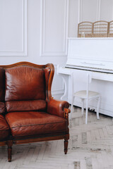 Vertical photo of a photo studio, cropped shot of the interior. Sofa on background of white interior