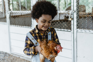 portrait cute boy farmer in farm with chicken © anut21ng Stock