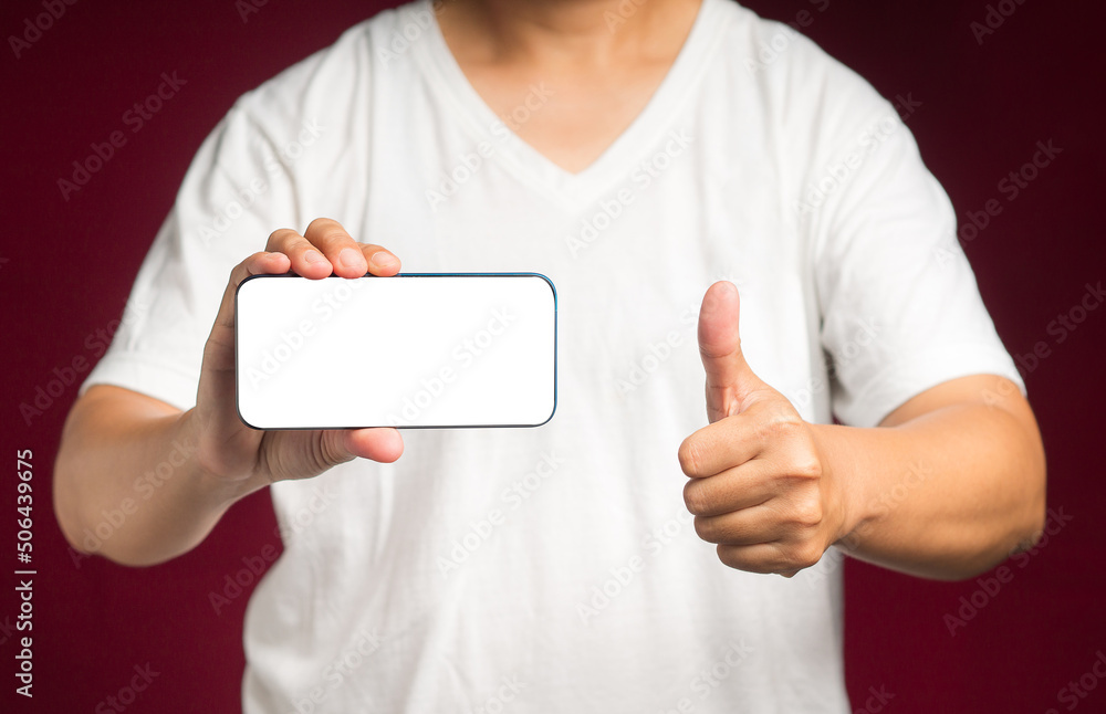 Poster hand holding a horizontal mobile phone with a blank white screen and showing thumbs up while standin