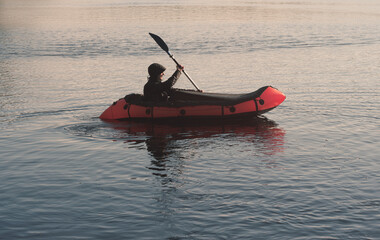 Man paddling on a packraft. Boat trip