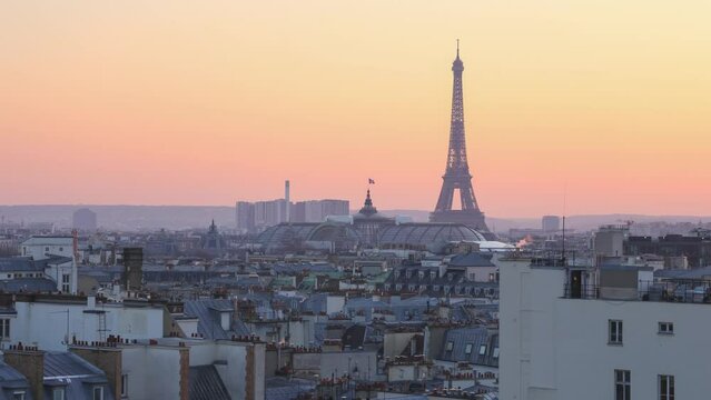 wide view time lapse of the rooftops and buildings at paris france with the eiffel tower on the background