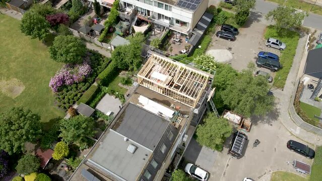 Aerial of wooden frame of roof structure under construction in a suburban neighborhood