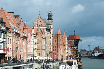 Motlawa River Embankment in Gdansk. View of the river with ships, the old town and the crane gate...