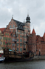 Pirate frigate on Motlawa River Embankment in Gdansk. View of the river with ships and the old...