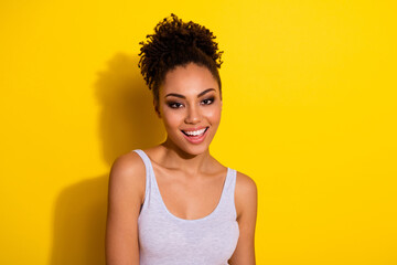 Portrait of adorable cheerful girl toothy beaming smile look camera isolated on bright yellow color background