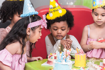 Group of  happy and enjoy kids have fun celebrating her birthday with Multinational friend kids birthday celebratiion party.