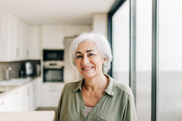 Happy elderly woman smiling cheerfully in her home